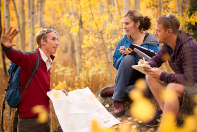 Colorado Mountain Students talk with a profession in an grove of aspens.